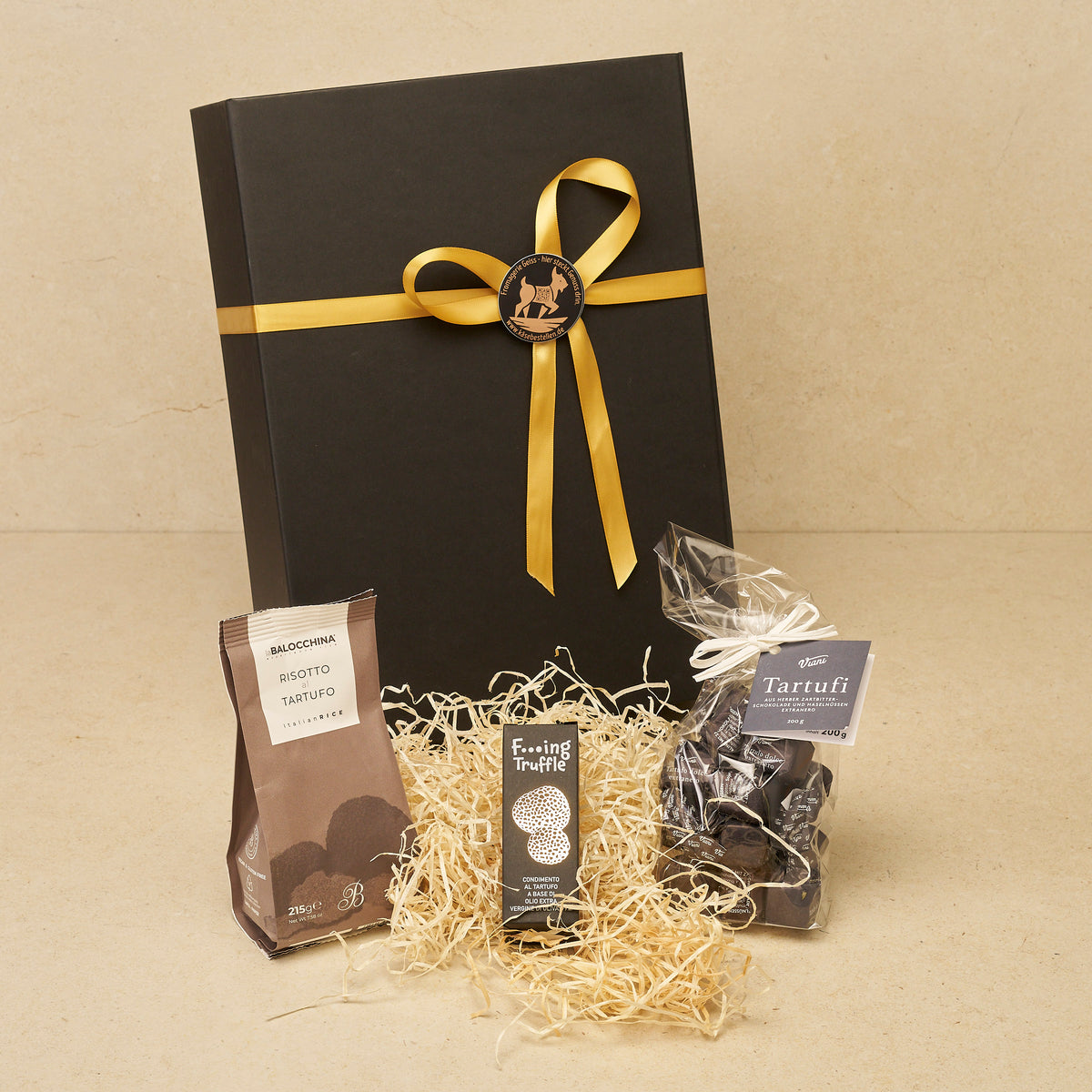 Geschenkbox Trüffelglück klein: Risotto al Tartufo, Trüffelöl und Tartufi Extraneri vor der schwarzen Magnetbox